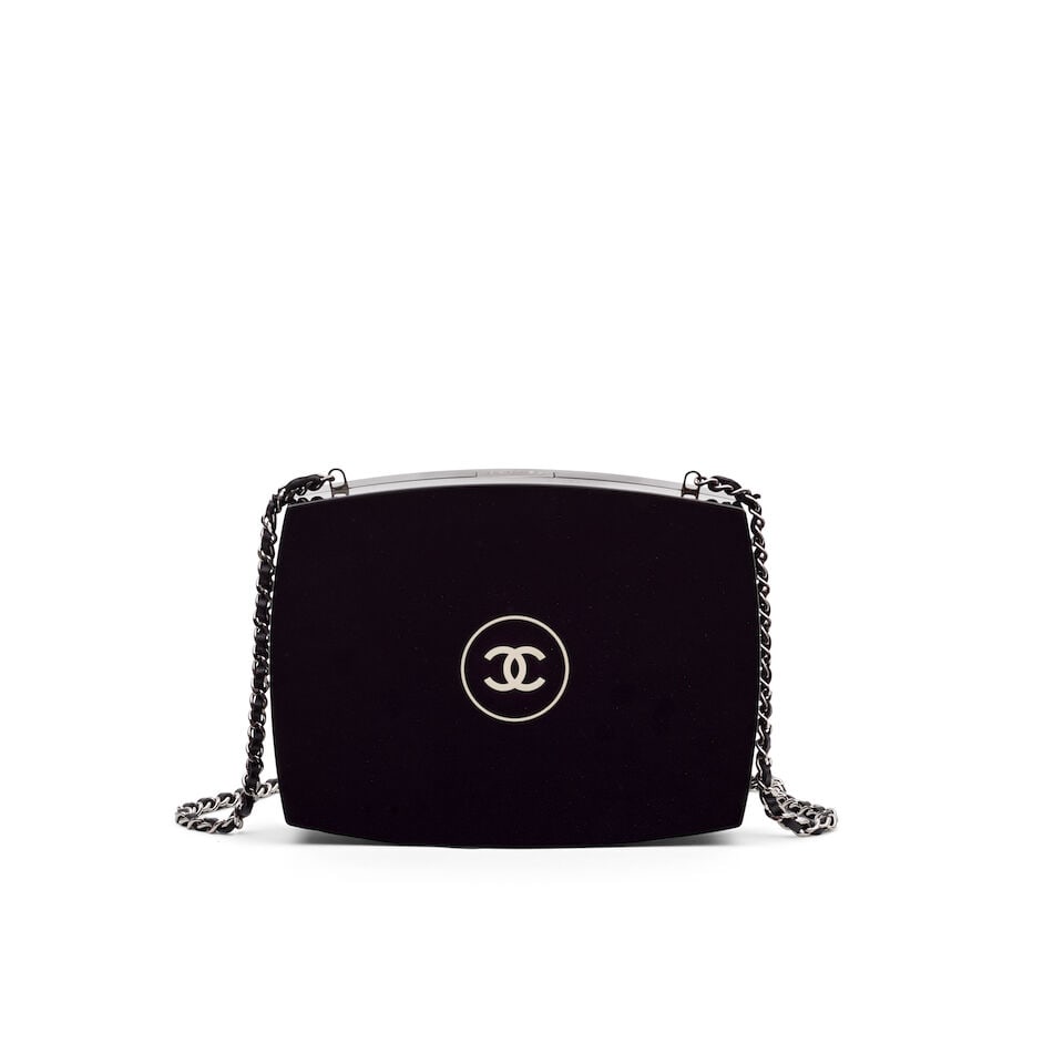Chanel: a Plexiglass Compact Powder CC Minaudière 2015-16 (includes serial sticker, authent...: Chanel: a Plexiglass Compact Powder CC Minaudière 2015-16 Creative Director: Karl Lagerfeld Black hard-sided clutch with white CC logo to front, modelled as a Chanel compact powder with a push lo