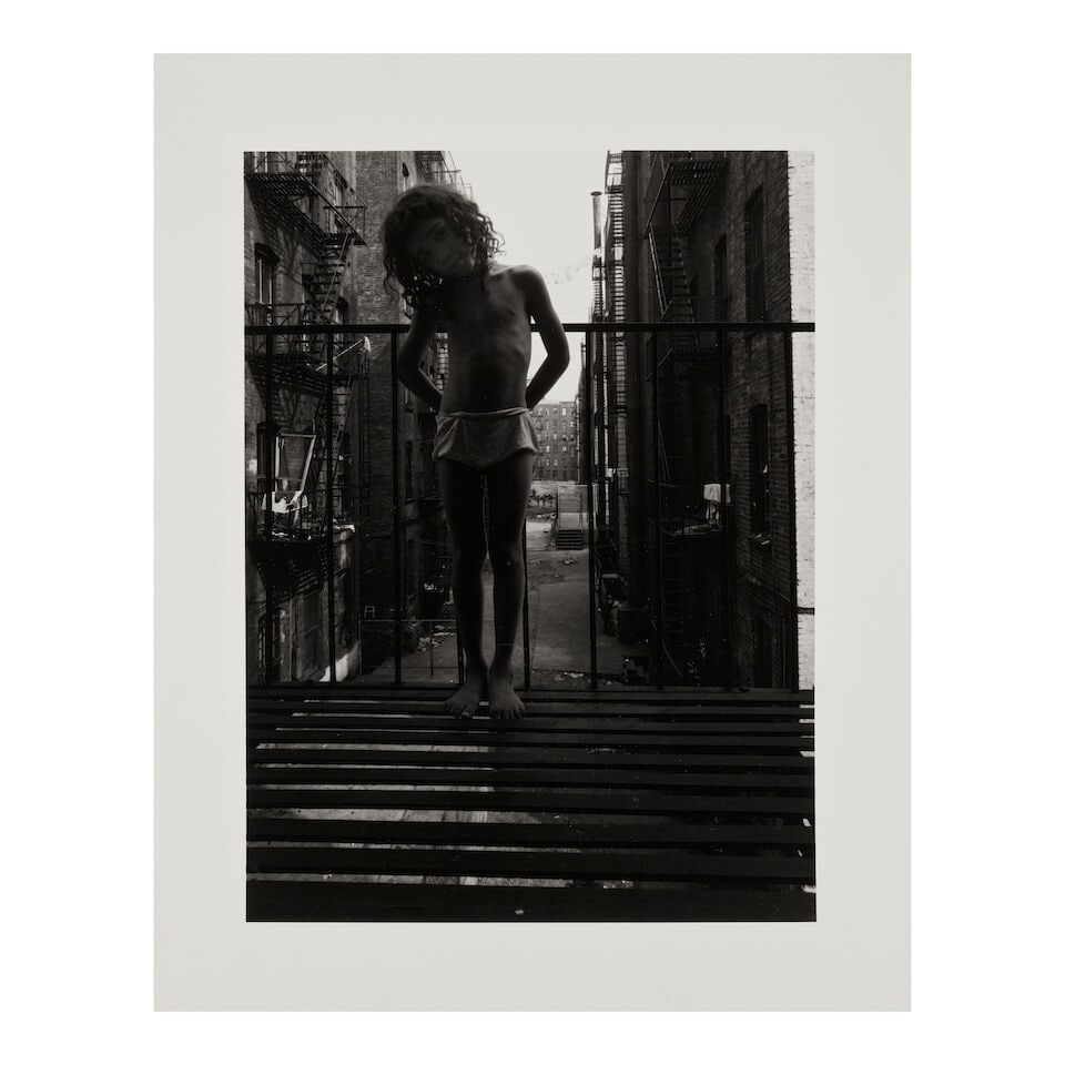 Bruce Davidson (born 1933); Child Standing on Fire Escape (from 'East 100th Street'); - 2