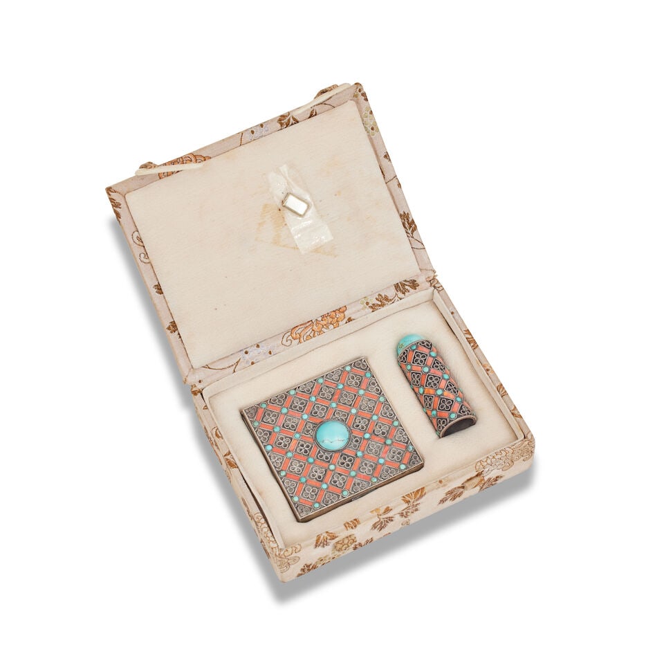 A Chinese silver compact set unmarked, early 20th century: A Chinese silver compact set unmarked, early 20th century The compact with hinged lid centred by a cabochon turquoise, and with a lattice of coral and turquoise, with a lipstick holder ensuite, in