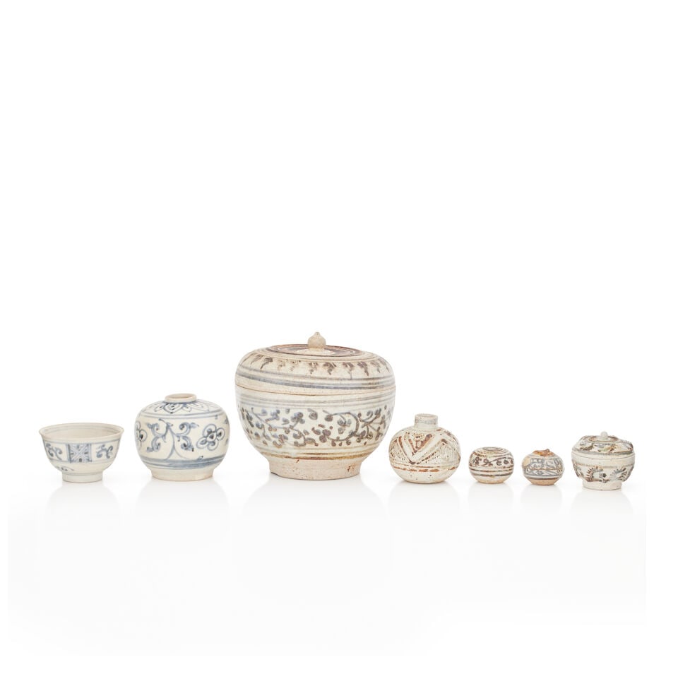 A Thai Sawankhalok jar and cover (7): A Thai Sawankhalok jar and cover Of circular form, the body painted with a band of scrolling foliage, 11cm high, 12.5cm diameter; together with three similar miniature jars, a bulbous vase 5cm high,