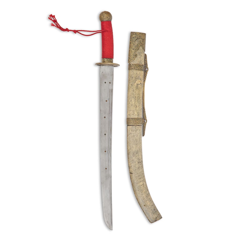 A Chinese brass mounted shagreen Dao sword: A Chinese brass mounted shagreen Dao sword Late Qing Dynasty The single edged blade with double fullered on each side and brass dots, the hilt with oval bronze guard and spiral red cord bound grip,