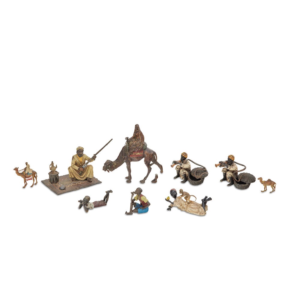 Franz Bergman (Austrian, 1861-1936): A group of cold painted bronzes (9): Franz Bergman (Austrian, 1861-1936): A group of cold painted bronzes Comprising of a cold painted bronze of a Nubian with rifle, seated on a rug, stamped foundry mark, 11.5cm high, 16cm wide;