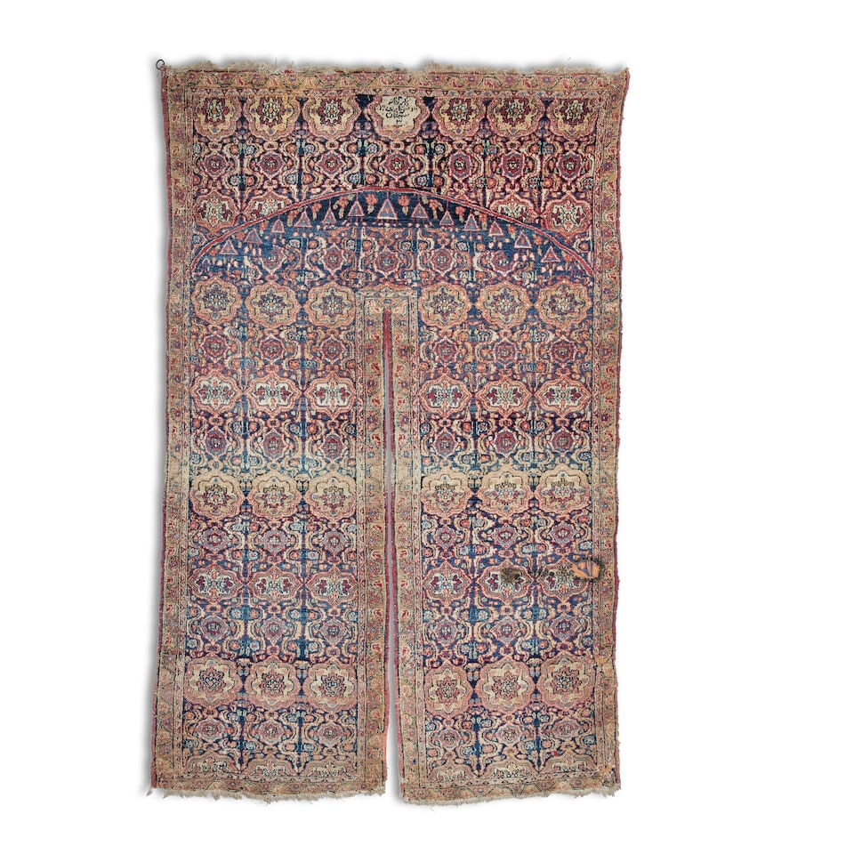 An unusual North-West Persian door hanging Early 20th century 208cm x 129cm wide.: An unusual North-West Persian door hanging Early 20th century Woven with an inscribed cartouche, archway and rows of alternating mina khani and arabesque floral cartouches, on an indigo ground, some