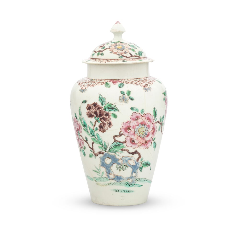 An attractive Bow vase and cover, circa 1750: An attractive Bow vase and cover, circa 1750 Of tapering oviform, the domed cover with pointed finial, decorated in a famille rose palette with large blooming peony branches issuing from hollow rockwo