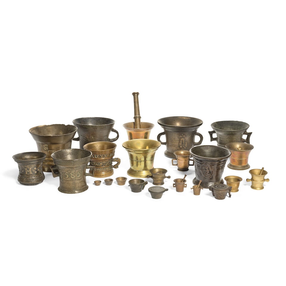 A small patinated bronze mortar cast with a relief portrait, probably depicting Charles II, toge...: A small patinated bronze mortar cast with a relief portrait, probably depicting Charles II, together with a collection of patinated and polished bronze and brass mortars and other related