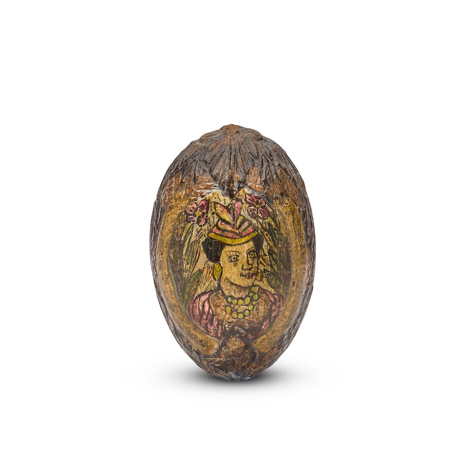 OF ETHNOGRAPHIC INTEREST: An unusual 19th century colonial carved and polychrome decorated cocon... (1 of 2)