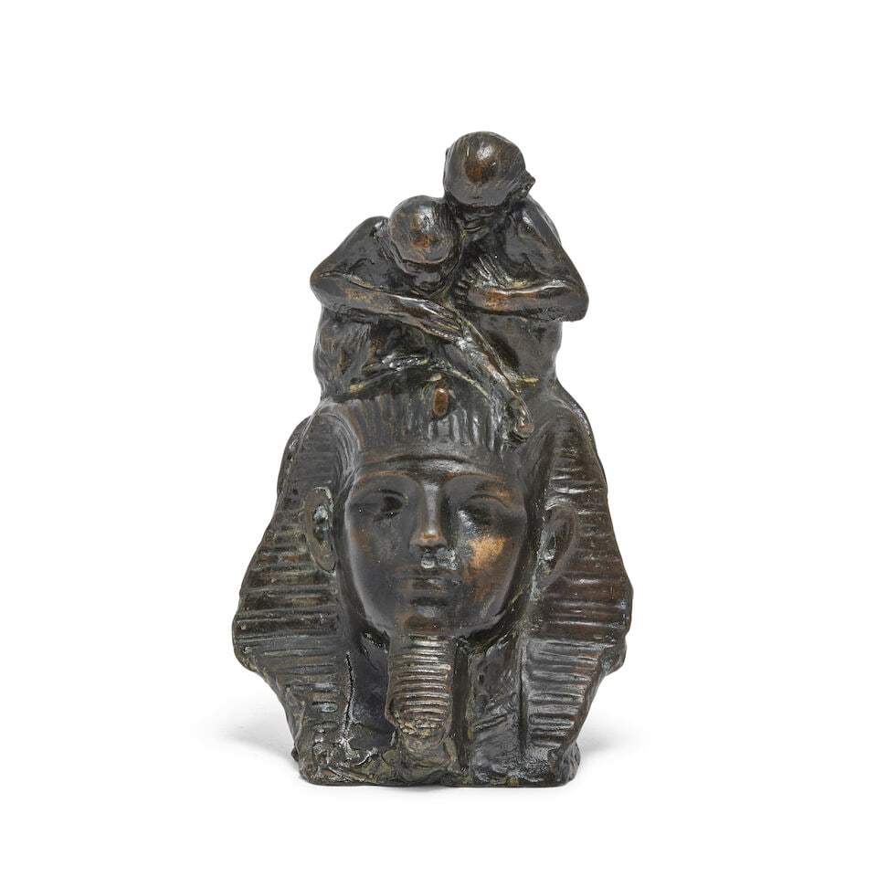 Richard Garbe (British, 1876-1957): A patinated bronze group of two monkeys sat on the head of a...: Richard Garbe (British, 1876-1957): A patinated bronze group of two monkeys sat on the head of a Sphinx Signed and dated Richard Garbe, 1920 The rear of the head with rusticated finish, signed and dat
