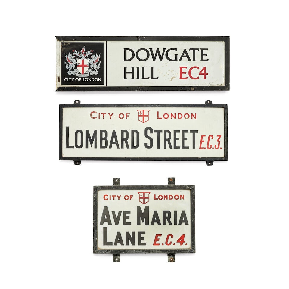 A group of three early 20th century cast iron and enamel London street signs (3): A group of three early 20th century cast iron and enamel London street signs For Dowgate Hill EC4, Lombard Street EC3 and Ave Marie Lane EC4, the largest 90cm wide, 30cm high, the smallest 46cm wide