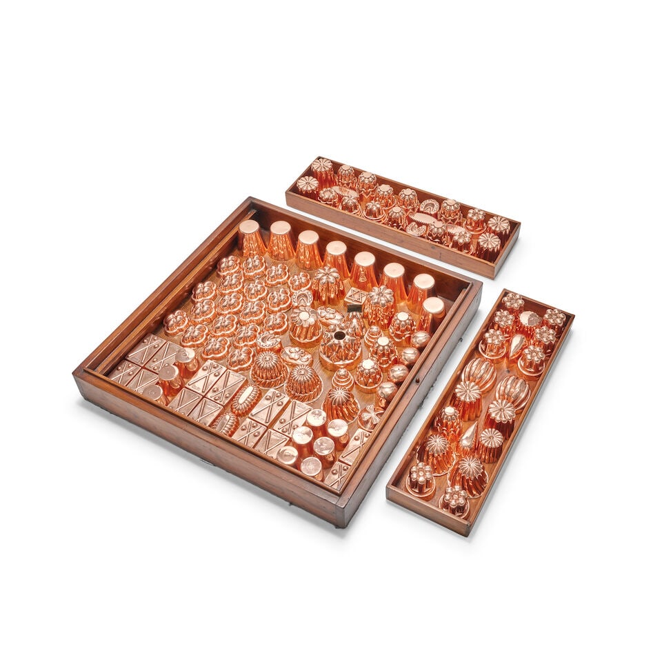 A good collection of late 19th century copper confectionery and jelly moulds of small size prese...: A good collection of late 19th century copper confectionery and jelly moulds of small size presented in an associated polished mahogany display box with twin inner trays and cover Comprising various n