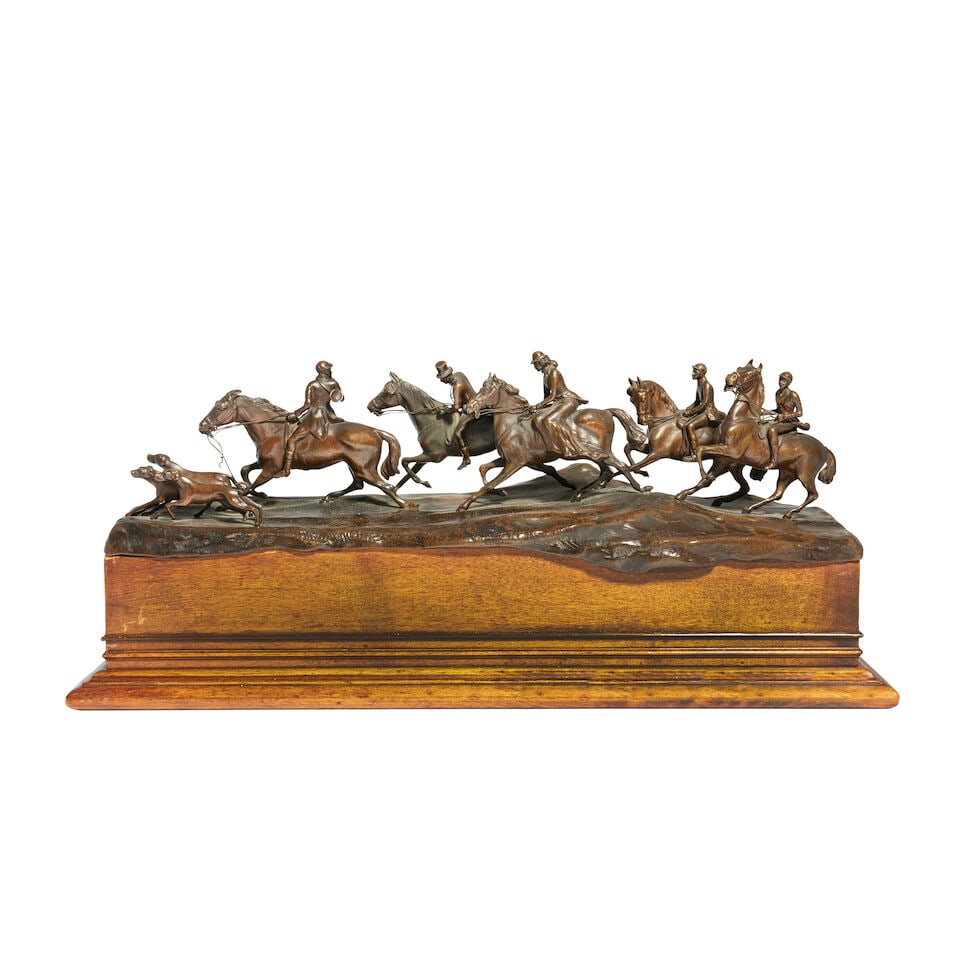 An early 20th century Continental patinated bronze figural group of a hunting scene: An early 20th century Continental patinated bronze figural group of a hunting scene The riders all in hunting attire on horseback led by three hounds, the master turning behind to blow his horn, on