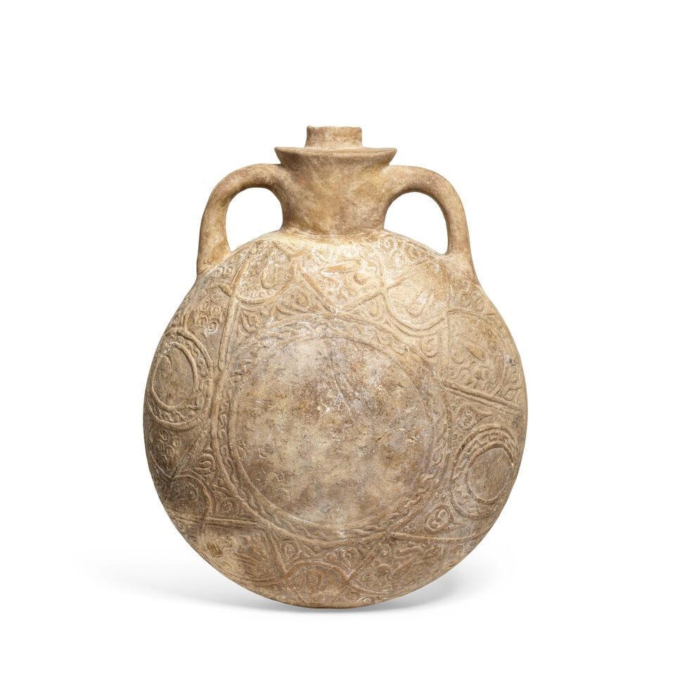 An unglazed moulded pottery pilgrim flask Persia, 12th/ 13th Century (1 of 2)