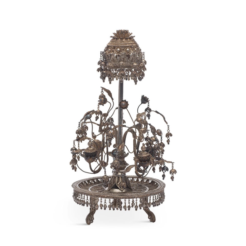 A silver filigree perfume-holder (attardan) India, late 19th/ early 20th Century: A silver filigree perfume-holder (attardan) India, late 19th/ early 20th Century comprising a rounded base with detachable floral sprays and flowerhead with integrated oil reservoirs, decorated in fil