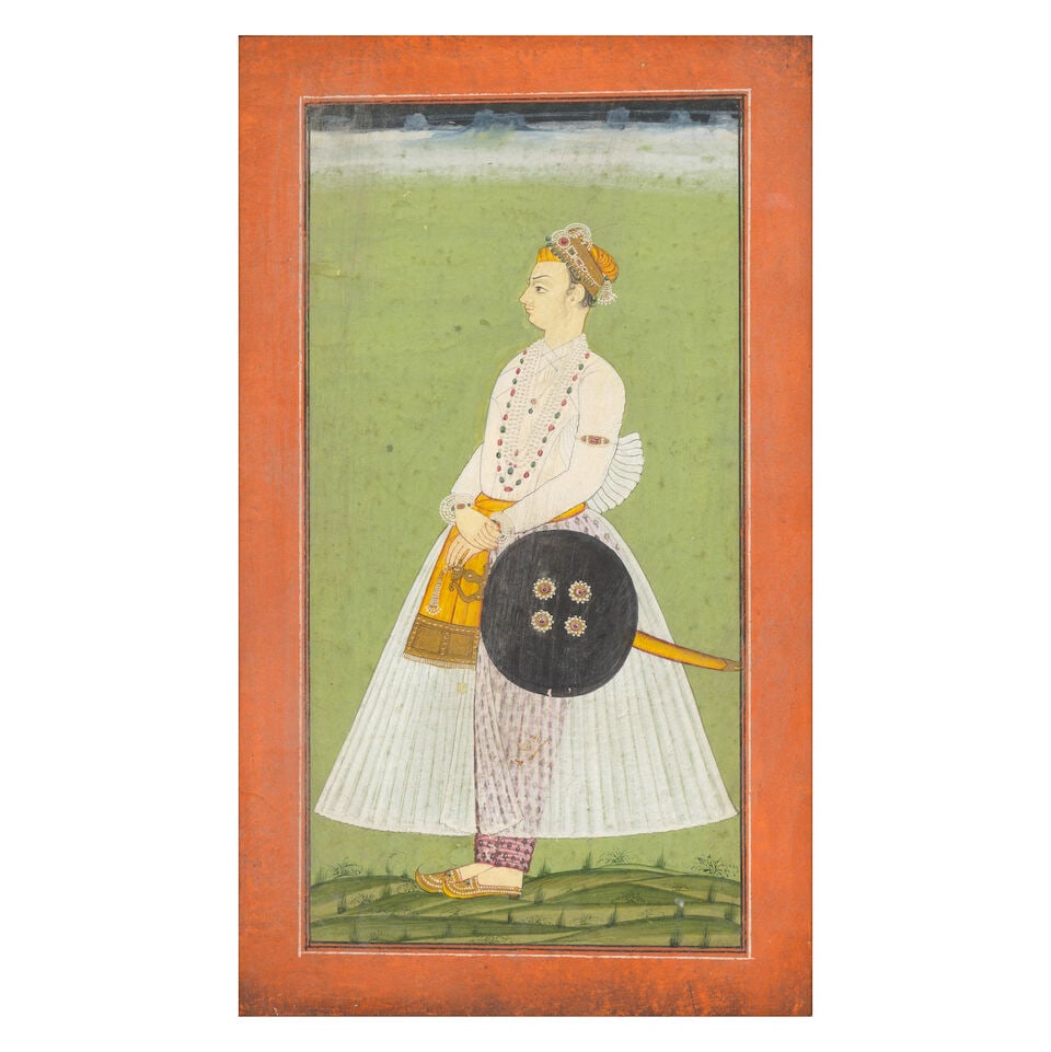 A bejewelled Rajput prince standing in a landscape, armed with sword and shield Provincial Mugha... (1 of 2)