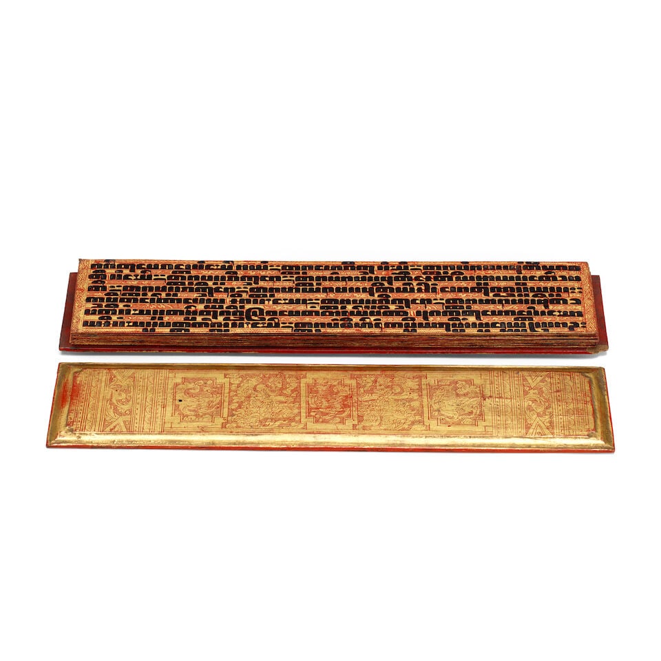 Sixteen gilt and lacquer leaves, and two gilded wood cover-boards, from a Kammavaca religious ma... (1 of 2)