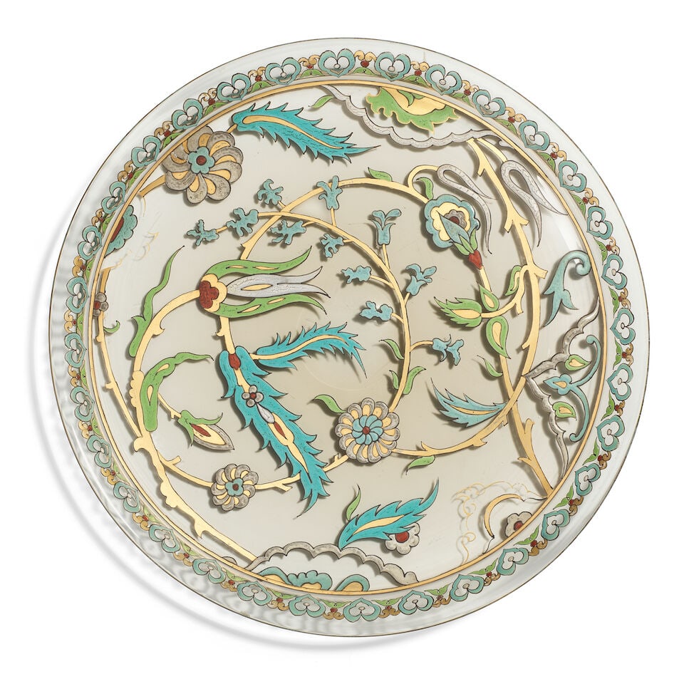 An enamelled glass dish for the Islamic market probably France, 19th/ 20th Century: An enamelled glass dish for the Islamic market probably France, 19th/ 20th Century of shallow rounded form with everted rim, decorated in polychrome enamel and gilt with floral sprays and partial lobe