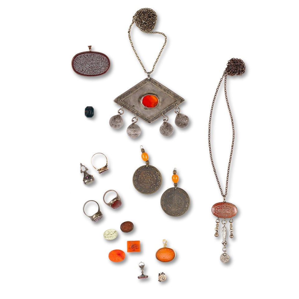 A group of inscribed carnelian and paste plaques, seals and jewellery Turkey, Persia and Central... (1 of 1)