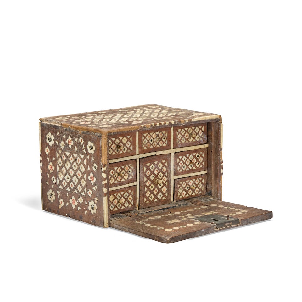 A Mughal bone-inlaid wood cabinet Gujarat or Sindh, 17th Century/ 18th Century: A Mughal bone-inlaid wood cabinet Gujarat or Sindh, 17th Century/ 18th Century of rectangular form with drop front opening to reveal eight drawers, brass lock plate to front, decorated in bone inlay w