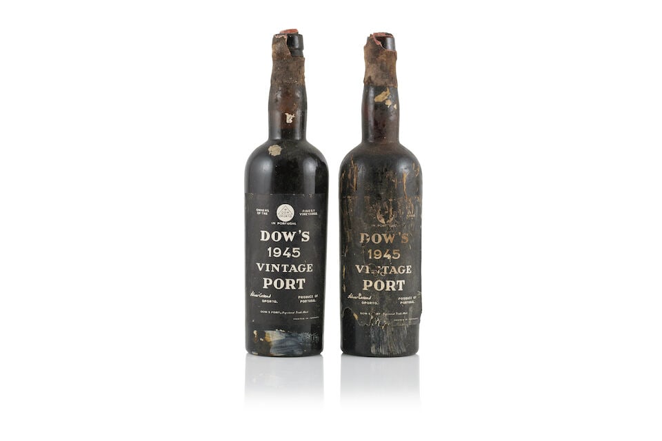 Dow, 1945 (2 x 750ml): Dow, 1945 (2 x 750ml) Region: Portugal Fill Level: 1 into neck, 1 mid shoulder Capsule: badly damaged wax seals - 1 with cork exposed Label: bin-soiled & damp-stained labels - 1 lightly, 1 badly &