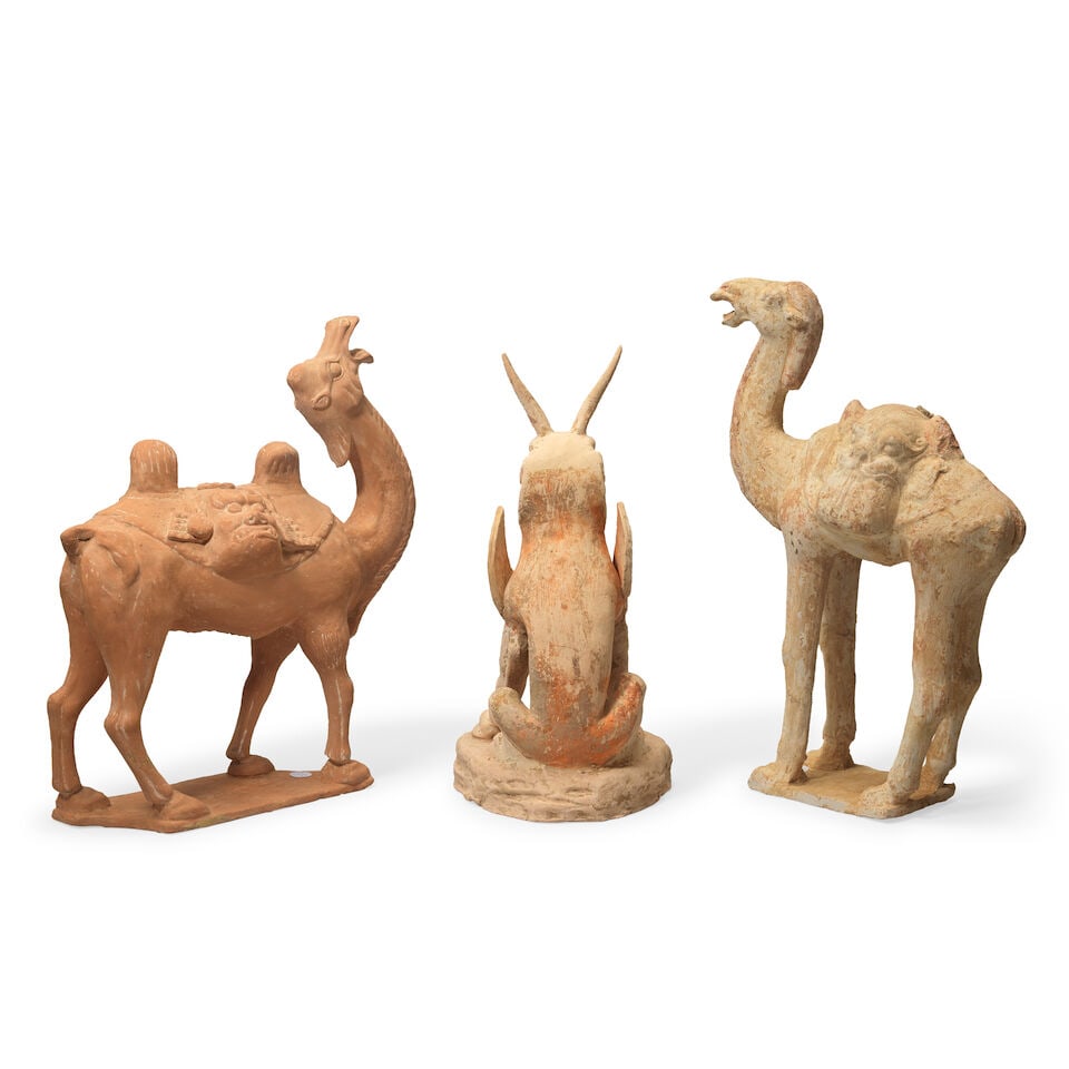 TWO TERRACOTTA MODELS OF CAPARISONED CAMELS AND A TERRACOTTA EARTH SPIRIT Probably Tang Dynasty... - 2
