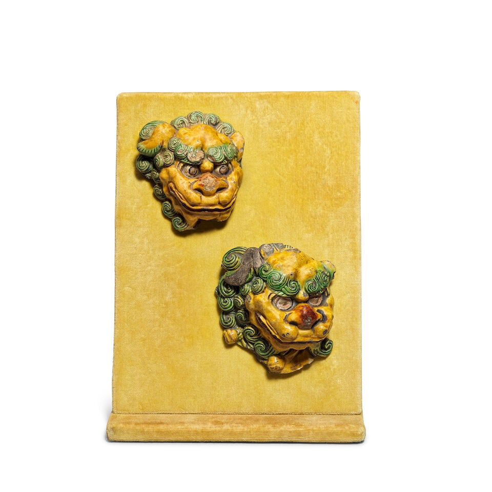 TWO SANCAI-GLAZED BUDDHIST LION HEAD FRAGMENTS Ming Dynasty, circa 1407-1431: TWO SANCAI-GLAZED BUDDHIST LION HEAD FRAGMENTS Ming Dynasty, circa 1407-1431 Each naturalistically modelled with bulging eyes wide nostrils and curiously grinning face, with tightly curled hair glazed