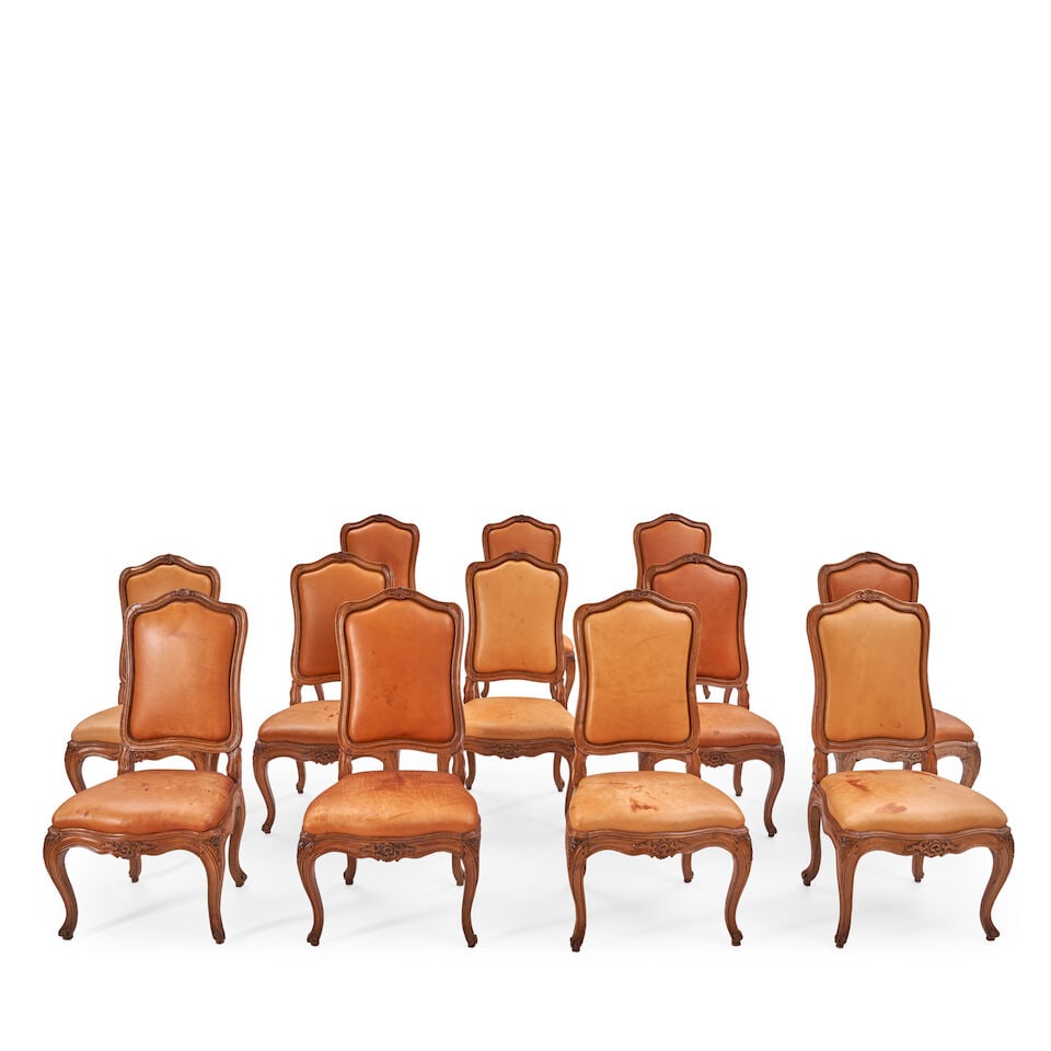 A Set of Twelve Louis XV Provincial Walnut Chaises, Possibly North Italian, Mid 18th Century,: A Set of Twelve Louis XV Provincial Walnut Chaises, Possibly North Italian, Mid 18th Century, the cartouche-form back with channeled frame upholstered in leather, above a shaped seat identically uphol