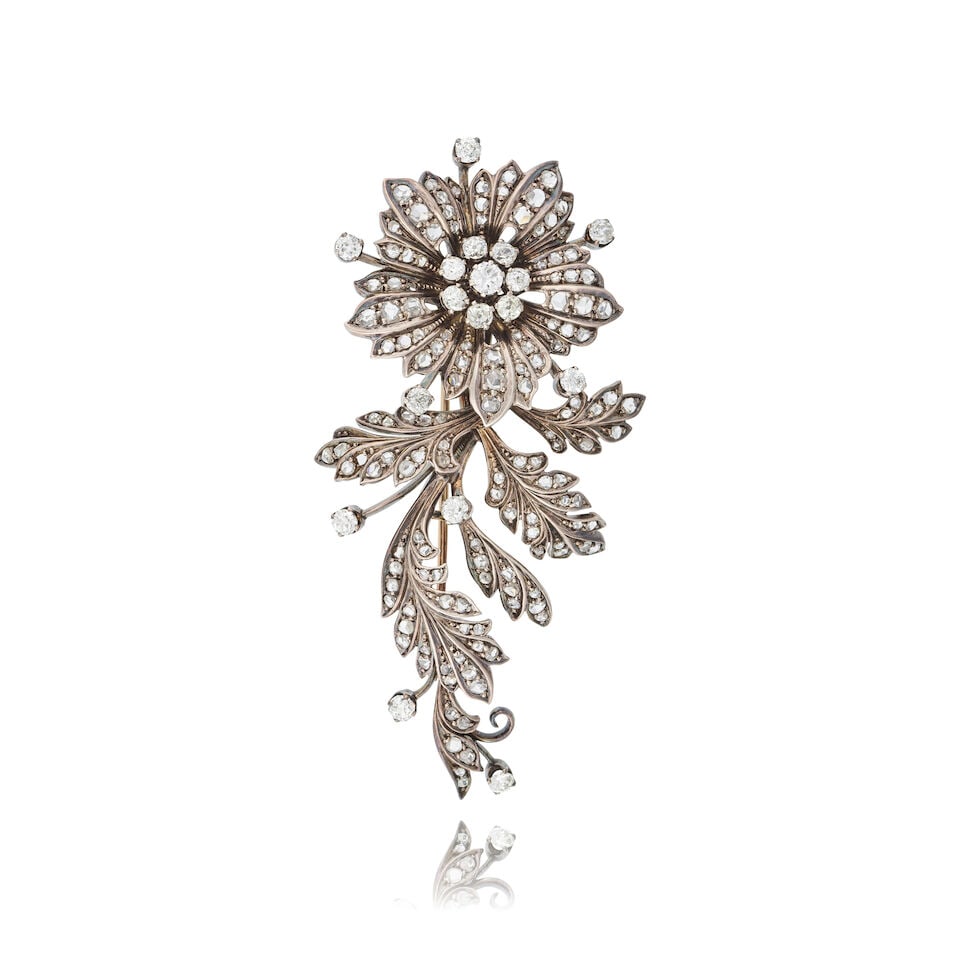 DIAMOND 'FLOWER' BROOCH BROCHE 'FLEUR' DIAMANTS: DIAMOND 'FLOWER' BROOCH BROCHE 'FLEUR' DIAMANTS • French import marks for 18 carat gold (750 ‰) and silver (800 ‰) • Stylised floral motif • Circular-cut, old-brilliant a