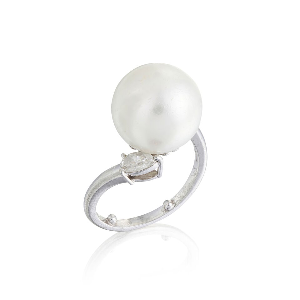 CULTURED PEARL AND DIAMOND RING BAGUE PERLE ET DIAMANTS: CULTURED PEARL AND DIAMOND RING BAGUE PERLE ET DIAMANTS • French import mark for platinum (850 ‰) • Set with a cultured pearl • 2 pear-cut diamonds weighing approximately 0.30