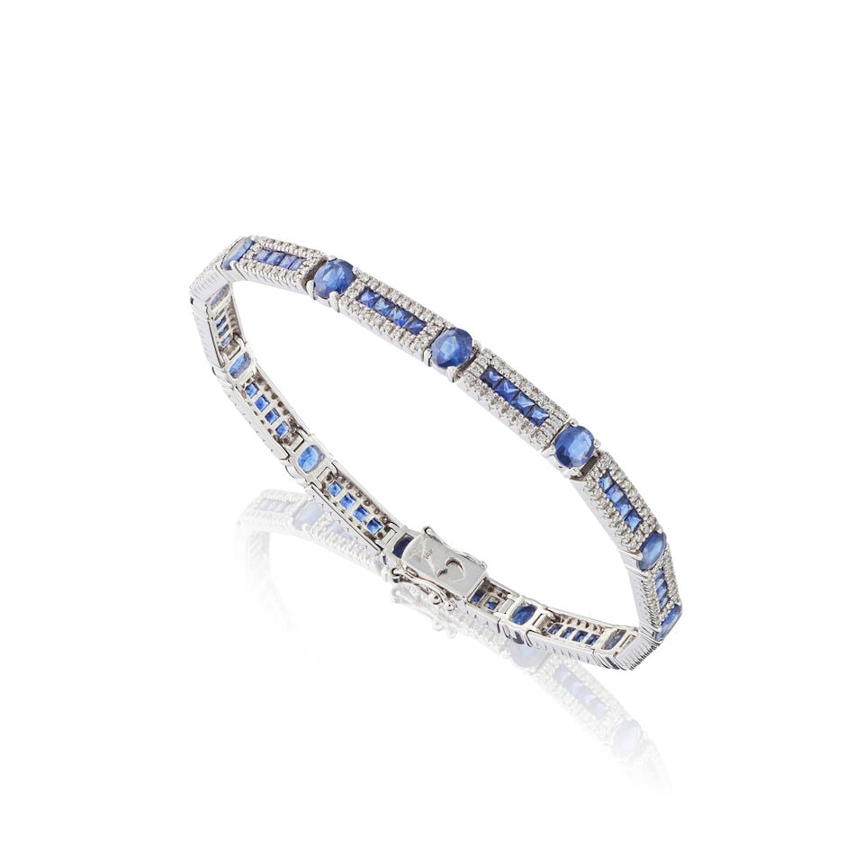 SAPPHIRE AND DIAMOND BRACELET BRACELET SAPHIRS ET DIAMANTS: SAPPHIRE AND DIAMOND BRACELET BRACELET SAPHIRS ET DIAMANTS • French import mark for 14 carat white gold (585 ‰) • 48 square-shaped sapphires and 12 oval-shaped sapphires weighing