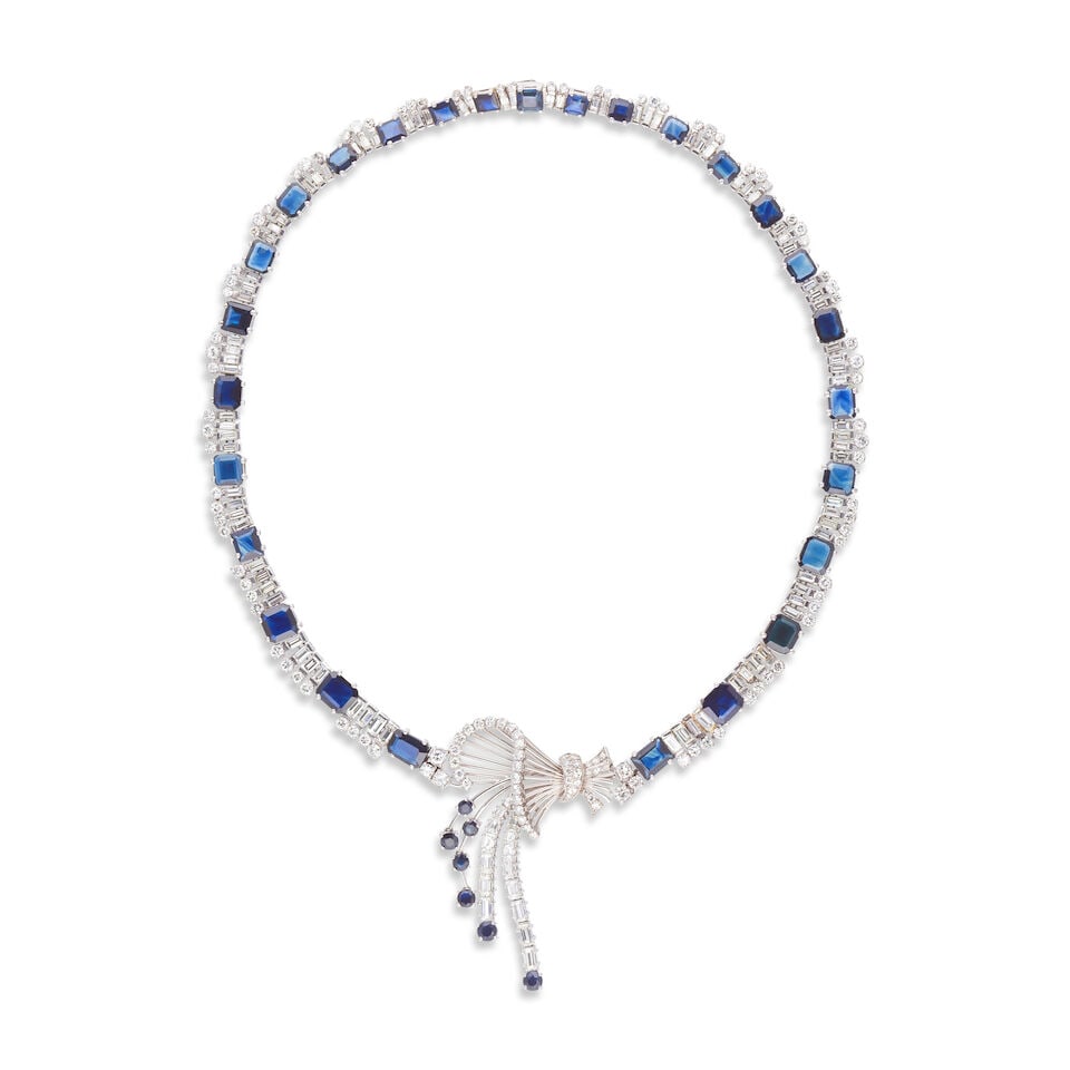 SAPPHIRE AND DIAMOND NECKLACE COLLIER SAPHIRS ET DIAMANTS: SAPPHIRE AND DIAMOND NECKLACE COLLIER SAPHIRS ET DIAMANTS • French import mark for 18 carat white gold (750 ‰) • The central motif stylizing an articulated ribbon pattern •