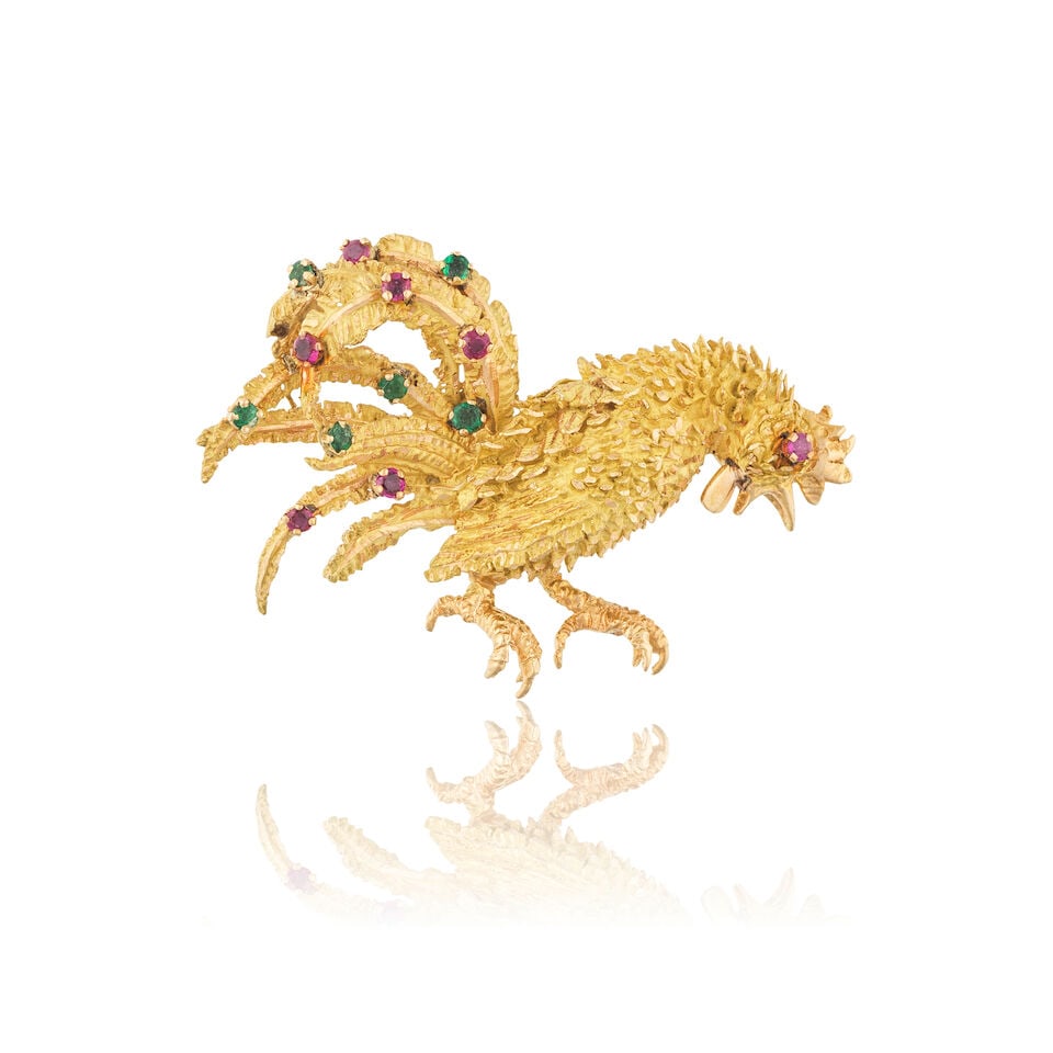 EMERALD AND RUBY 'ROOSTER' BROOCH BROCHE 'COQ' ÉMERAUDES ET RUBIS: EMERALD AND RUBY 'ROOSTER' BROOCH BROCHE 'COQ' ÉMERAUDES ET RUBIS • French assay mark for 18 carat yellow gold (750 ‰) • Of rooster design • 6 circular-cut emeralds