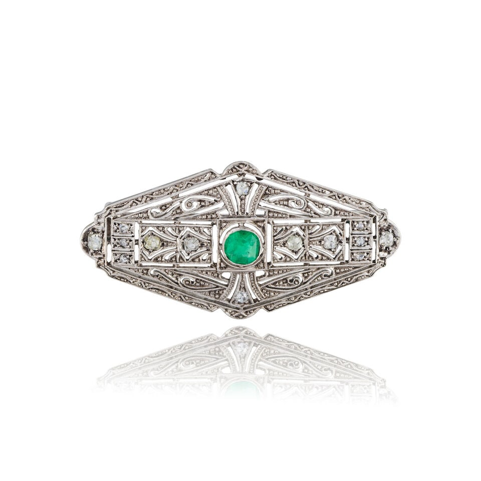 EMERALD AND DIAMOND BROOCH BROCHE ÉMERAUDE ET DIAMANTS: EMERALD AND DIAMOND BROOCH BROCHE ÉMERAUDE ET DIAMANTS • French import marks for 14 carat white gold (585 ‰) • Circular-cut emerald weighing approximately 0.40 ct • 14