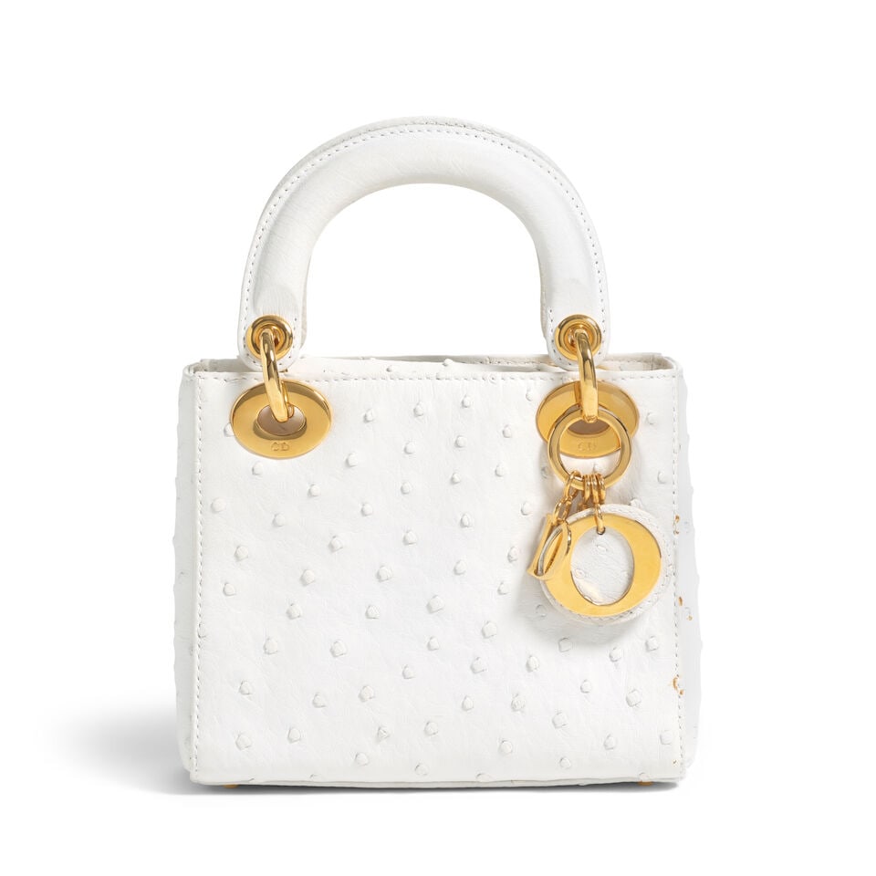 CHRISTIAN DIOR: WHITE OSTRICH MINI LADY DIOR 2003 | John Galliano: CHRISTIAN DIOR: WHITE OSTRICH MINI LADY DIOR 2003 | John Galliano • White Ostrich Exterior • Gold Tone Hardware and Protective Feet at Base • Fold In Flap Closure • Dual