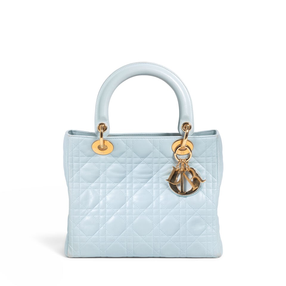 CHRISTIAN DIOR: BLUE LEATHER CANNAGE MEDIUM LADY DIOR 1997 | John Galliano: CHRISTIAN DIOR: BLUE LEATHER CANNAGE MEDIUM LADY DIOR 1997 | John Galliano • Blue Leather Cannage Quilted Exterior • Gold Tone Hardware and Protective Feet at Base • Zipper Closure &