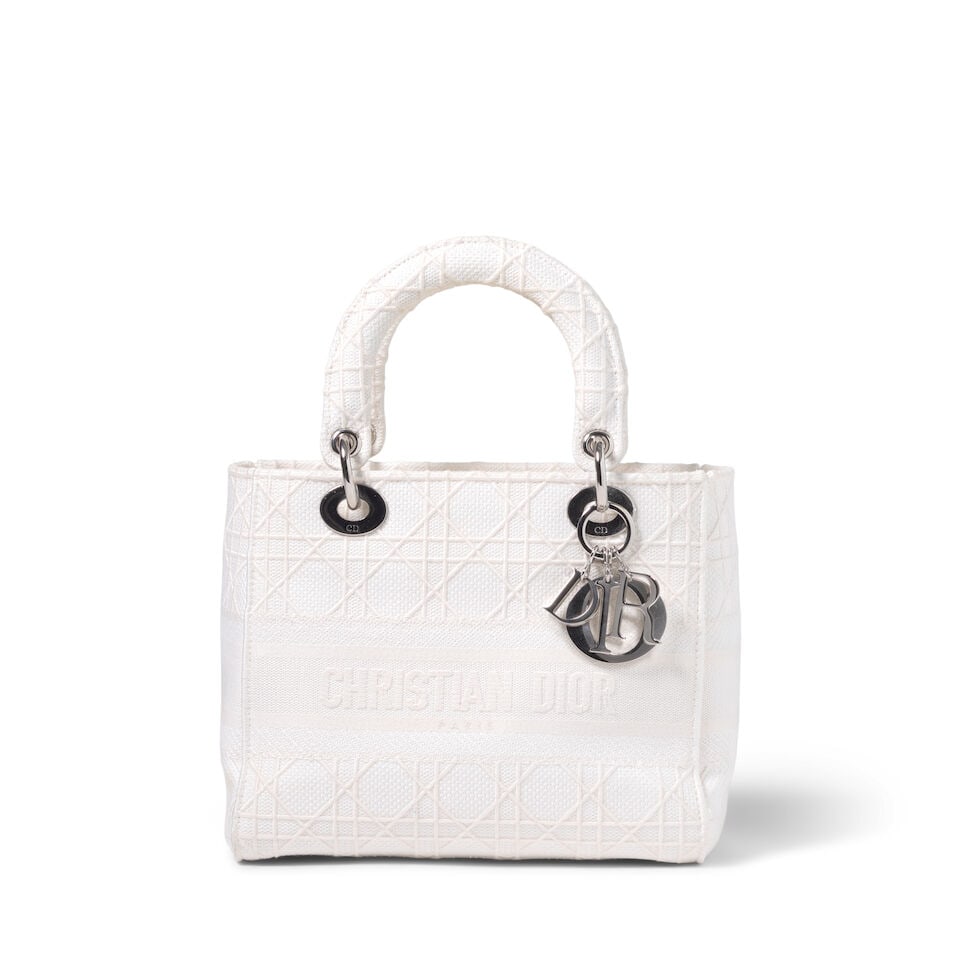 CHRISTIAN DIOR: WHITE EMBROIDERED CANNAGE CANVAS MEDIUM D-LITE 2020 | Maria Grazia Chiuri: CHRISTIAN DIOR: WHITE EMBROIDERED CANNAGE CANVAS MEDIUM D-LITE 2020 | Maria Grazia Chiuri • White Canvas Cannage Embroidered Exterior • Silver Tone Hardware and Protective Feet at Base