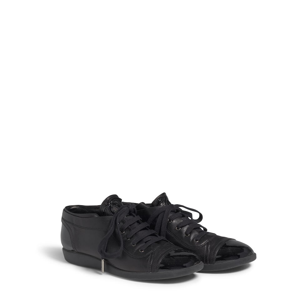 CHANEL: BLACK LEATHER LOGO SNEAKERS: CHANEL: BLACK LEATHER LOGO SNEAKERS • Marked Size 39 1/2 Footnotes: OVERALL CONDITION: Good | Wear throughout. The Condition Report represents Bonhams' reasonable opinion as to the Lot's general