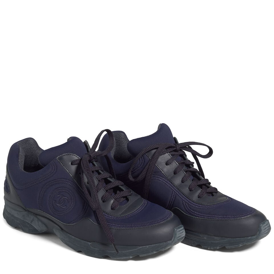 CHANEL: NAVY NEOPRENE LOGO SNEAKERS: CHANEL: NAVY NEOPRENE LOGO SNEAKERS • Marked Size 39 1/2 Footnotes: OVERALL CONDITION: Good | Wear throughout. The Condition Report represents Bonhams' reasonable opinion as to the Lot's general