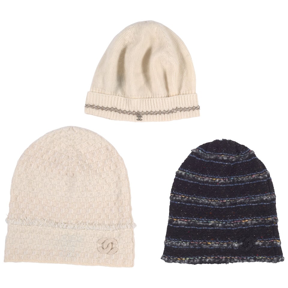 CHANEL: A GROUP OF THREE BEANIES: CHANEL: A GROUP OF THREE BEANIES • Includes: Cream Fringe Beanie with Gold Lurex Detail, White Cashmere Beanie with Silver Chain Trim, Black with Multicolor Stripes • Beanies All One Size