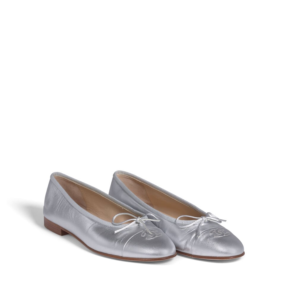 CHANEL: SILVER INTERLOCKING CC LOGO BALLET FLATS: CHANEL: SILVER INTERLOCKING CC LOGO BALLET FLATS • Marked Size 39 1/2 Footnotes: OVERALL CONDITION: Good | Wear on exterior soles. Slight wear on interior. The Condition Report represents Bonham