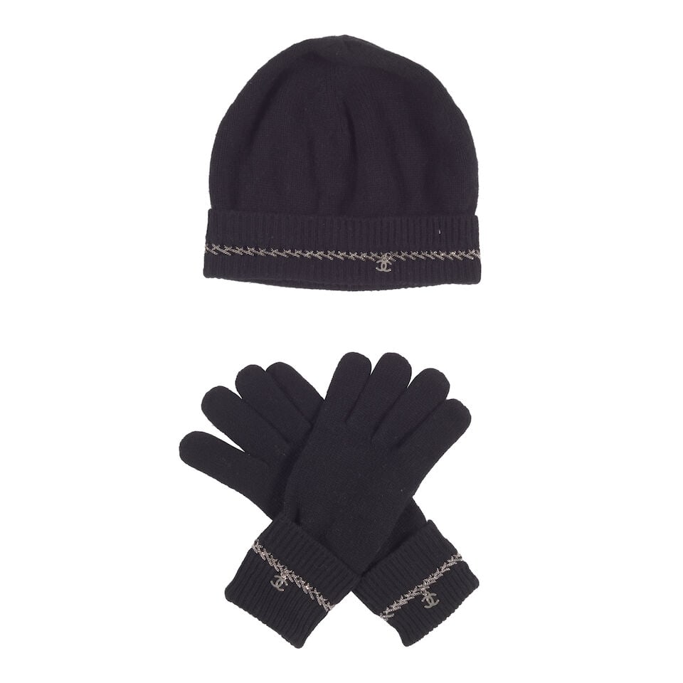CHANEL: A SET OF BLACK CASHMERE ACCESSORIES WITH CC CHARM AND CHAIN DETAIL: CHANEL: A SET OF BLACK CASHMERE ACCESSORIES WITH CC CHARM AND CHAIN DETAIL • Set Includes: Beanie and a Pair of Gloves • Beanie and Gloves One Size OVERALL CONDITION: Very Good | Light sig