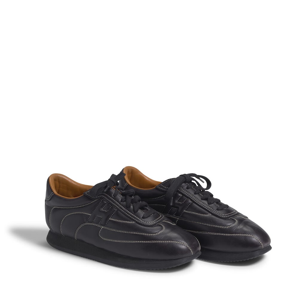 HERMÈS: BLACK H 'QUICK' LEATHER SNEAKERS: HERMÈS: BLACK H 'QUICK' LEATHER SNEAKERS • Marked Size 39 Footnotes: OVERALL CONDITION: Good | Slight wear throughout. The Condition Report represents Bonhams' reasonable opinion as to the