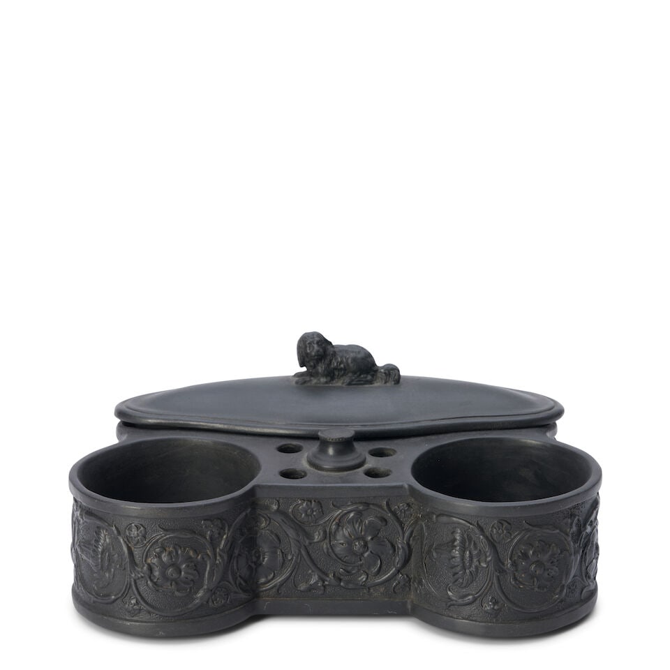 Wedgwood Black Basalt Inkstand, England, 19th century,: Wedgwood Black Basalt Inkstand, England, 19th century, spaniel finial to a covered container by two wells and central pen holes, banded arabesque floral decoration, impressed mark, lg. 8