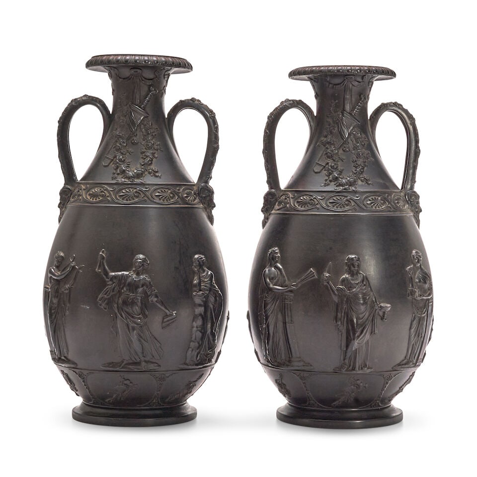 Large Pair of Wedgwood Black Basalt Vases, England, 19th century,: Large Pair of Wedgwood Black Basalt Vases, England, 19th century, bottle shapes with loop handles terminating at satyr masks and with trophies at their necks above a band of anthemion and with classic
