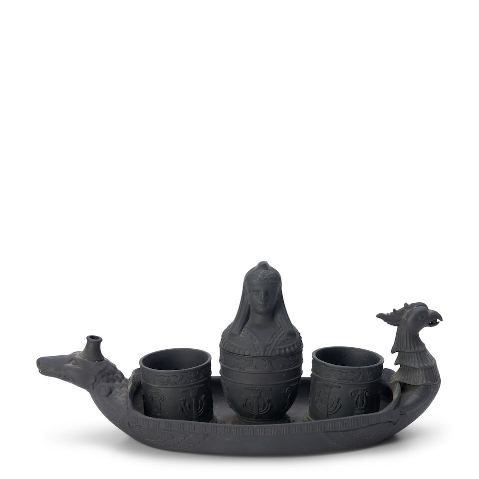 Black Basalt Egyptian Inkstand, England, early 19th century,: Black Basalt Egyptian Inkstand, England, early 19th century, boat-shaped tray with crocodile and phoenix bird handles, set with two cylinders flanking a central canopic jar/inkwell decorated with