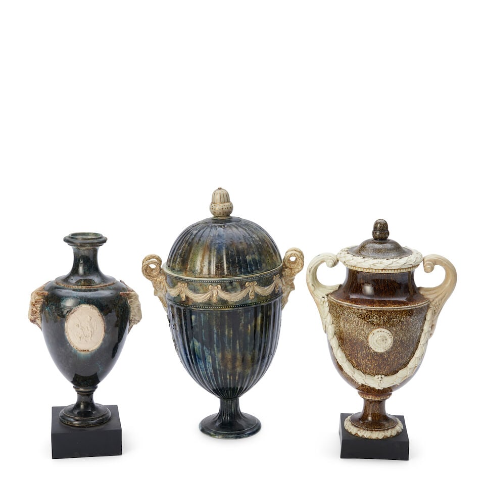 Three Wedgwood 18th Century Vases, England,: Three Wedgwood 18th Century Vases, England, a brown granite ground vase and cover with scrolled handles and laurel and berry festoons in high relief, set on a black basalt plinth, impressed upper-lowe