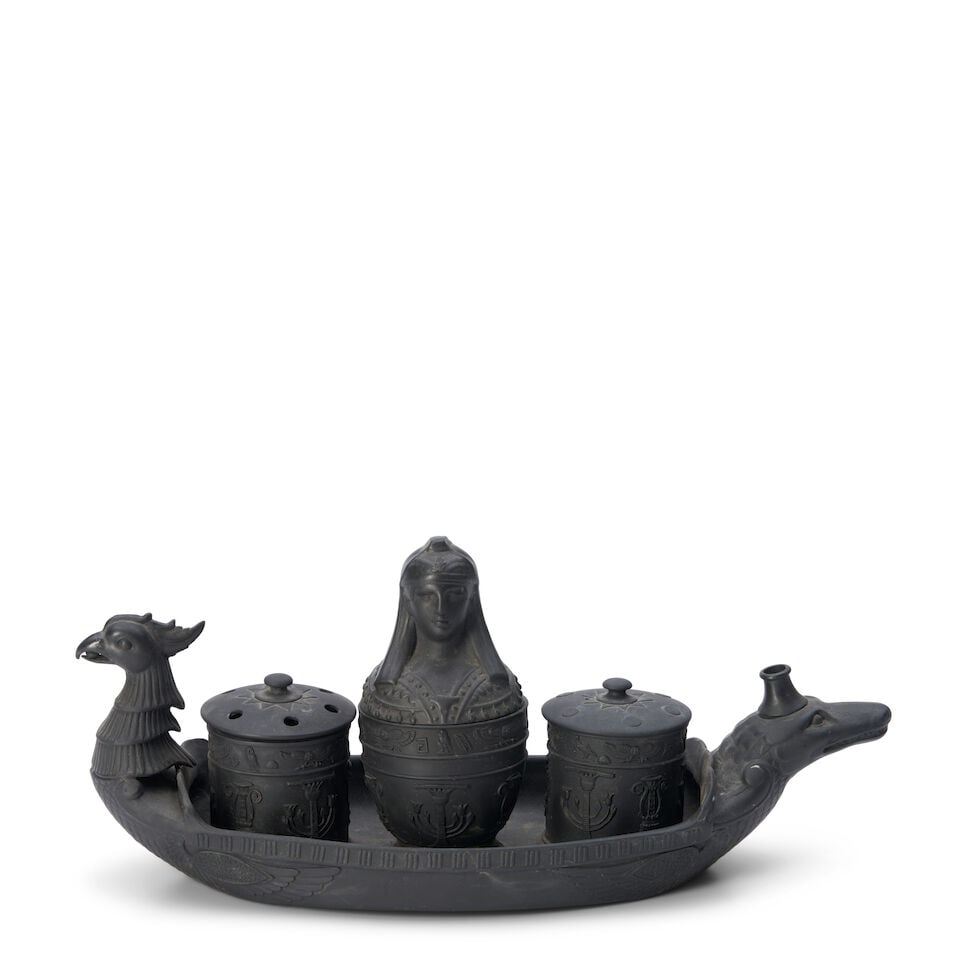 Wedgwood Black Basalt Egyptian Boat-shaped Inkstand, England, 19th century,: Wedgwood Black Basalt Egyptian Boat-shaped Inkstand, England, 19th century, phoenix head and crocodile handles, set with two cylindrical sanders and covers flanking a central canopic jar-shaped inkwel