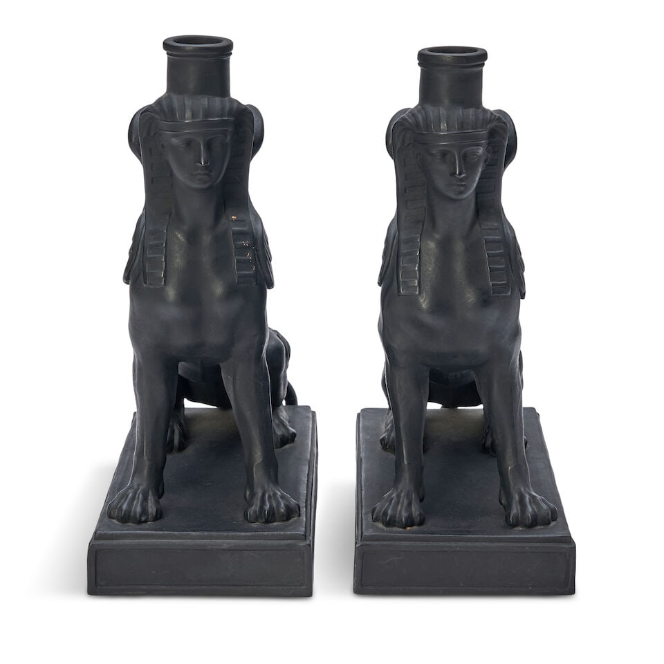 Pair of Wedgwood Black Basalt Sphinx Candlesticks, England, early 19th century,: Pair of Wedgwood Black Basalt Sphinx Candlesticks, England, early 19th century, each winged figure modeled seated atop a raised rectangular plinth, impressed mark, ht. 9 3/4 in. For further