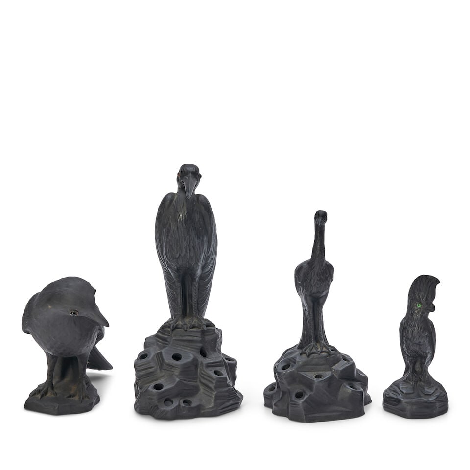Four Wedgwood Black Basalt Birds, England, 20th century,: Four Wedgwood Black Basalt Birds, England, 20th century, a cockatoo, ht. 4 1/4; egret on as rock, ht. 7 1/4; raven, ht. 4 1/4; and crane on a rock, ht. 6 1/4 in.; impressed marks. For further