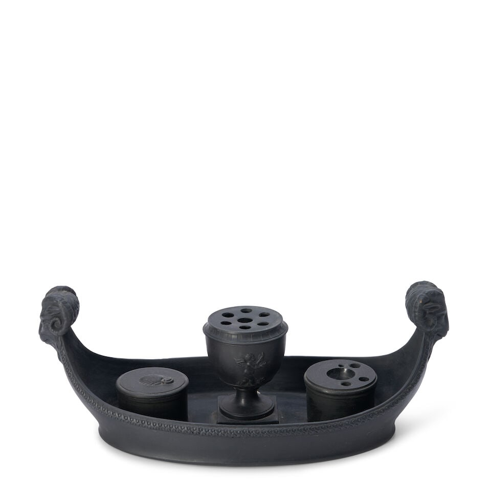 Wedgwood Black Basalt Boat-form Inkstand, England, early 19th century,: Wedgwood Black Basalt Boat-form Inkstand, England, early 19th century, ram's head handles to an oval shape fitted with cylindrical inkwell and sander flanking a central cup shape with pierced cover,