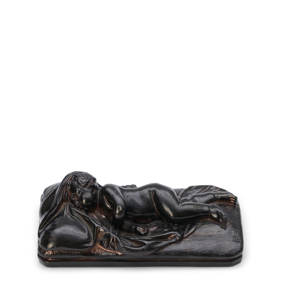 Wedgwood Black Glazed Stoneware Somnus, England, 19th century,: Wedgwood Black Glazed Stoneware Somnus, England, 19th century, with traces of copper lustring, modeled as a sleeping infant on a blanketed rectangular base, impressed mark, lg. 5 1/4 in. For further
