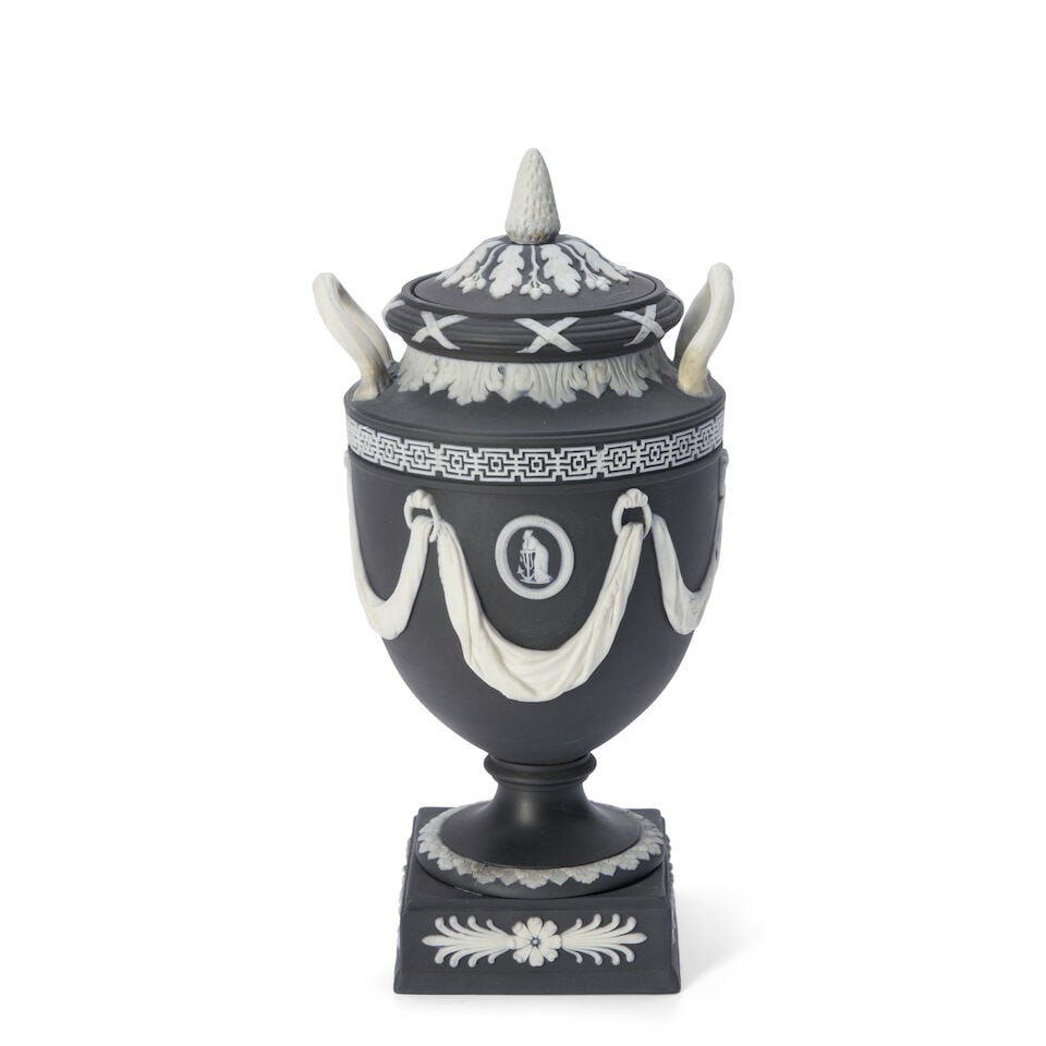 Wedgwood Black Jasper Dip Vase and Cover, England, late 19th/early 20th century,: Wedgwood Black Jasper Dip Vase and Cover, England, late 19th/early 20th century, upturned loop handles, applied white relief with classical medallions within drapery swags, impressed mark, ht. 9 3/4 i